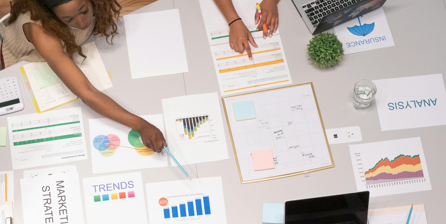 Woman pointing a chart on a paper.